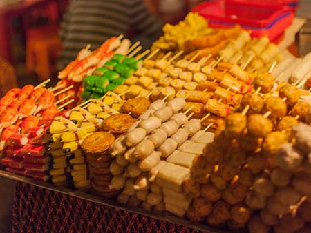 Various processed meats on skewers