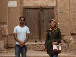 Travis and Sonya with a large wooden door